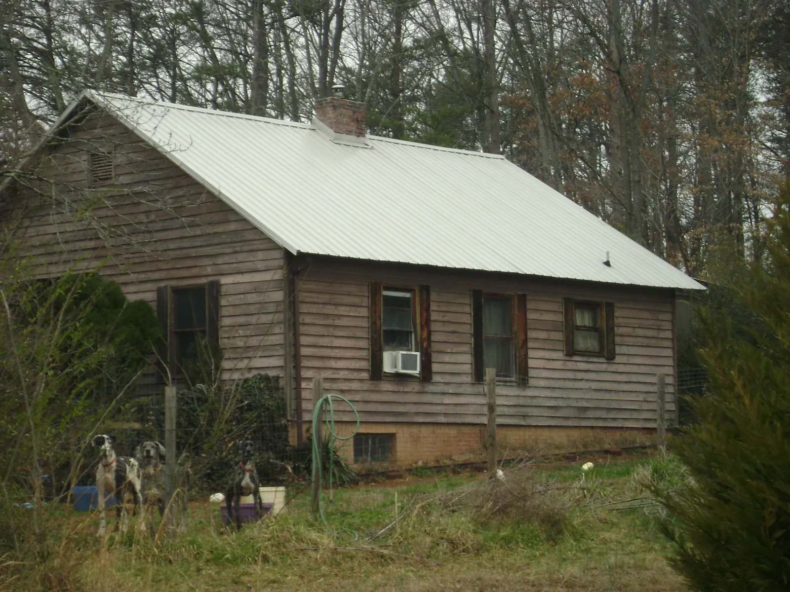 White metal roof on an old wood sided farmhouse, from a Asphalt Shingle Roof Repair job in Pen Argyl